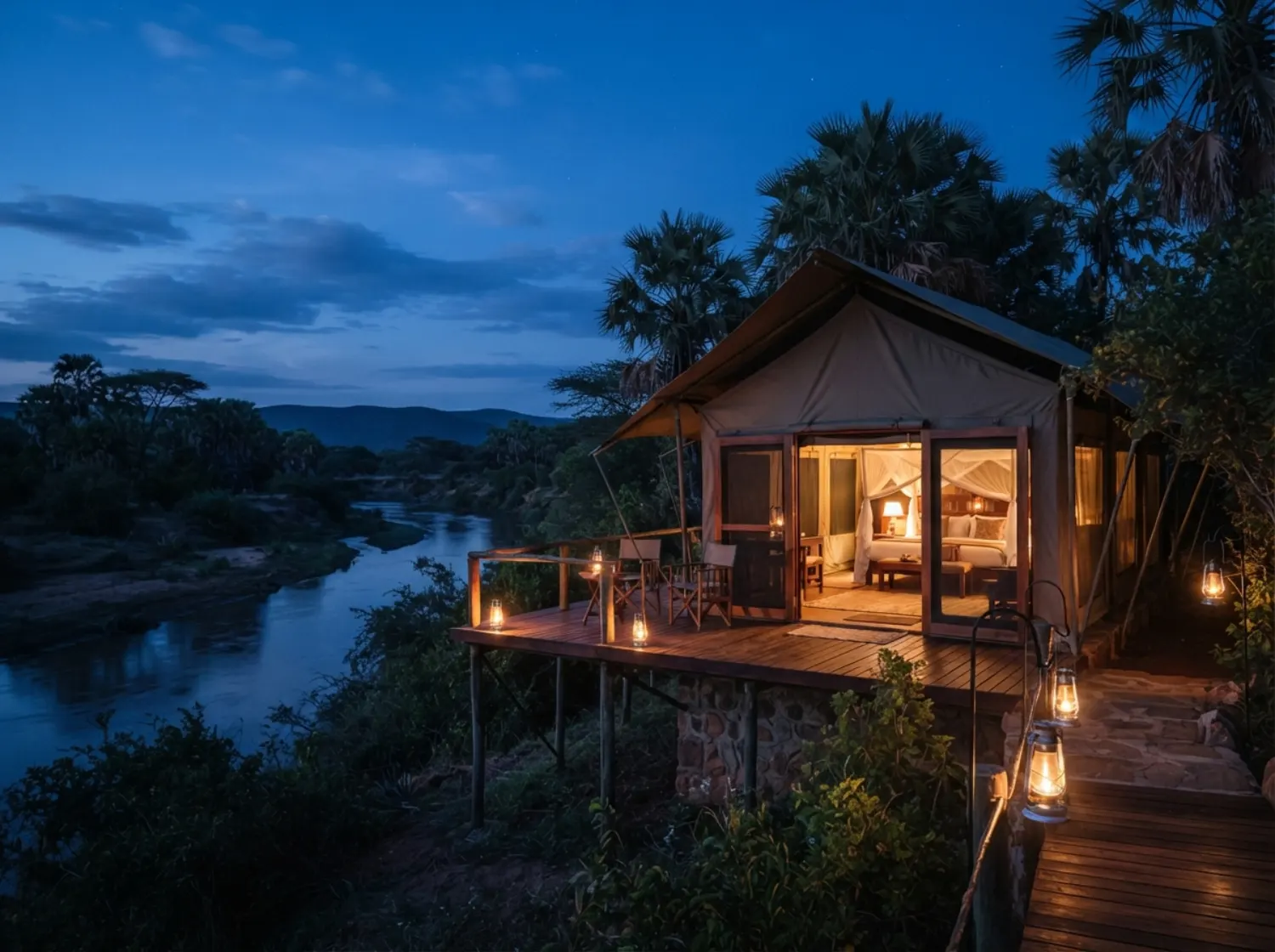 Luxury riverbank tented safari camp at dusk in Samburu